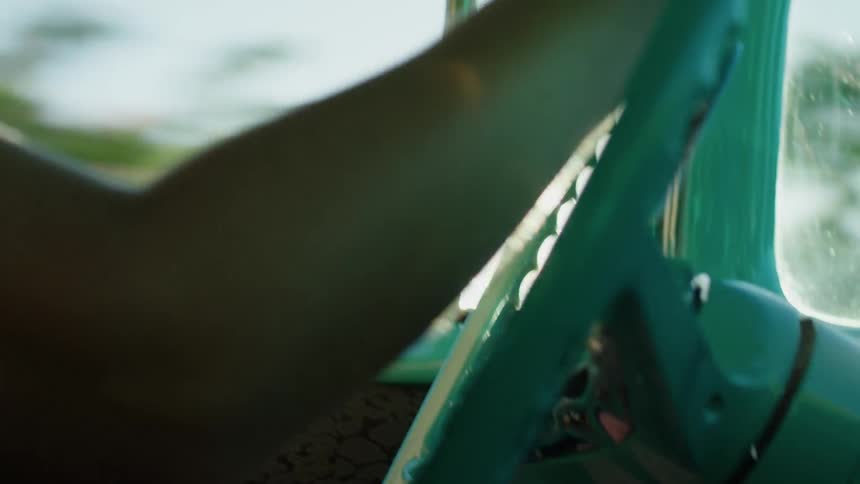 A man is driving a bill colored classic car