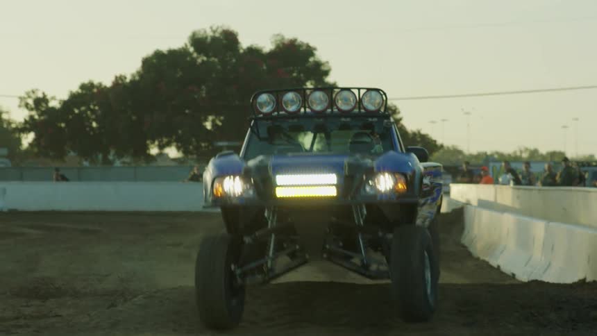 A rally truck drives through a course