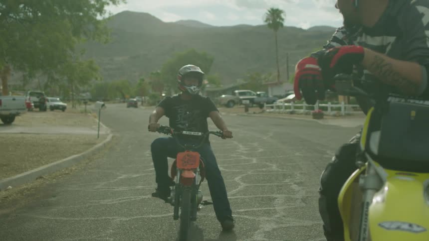 Young men ride pocket bikes on the street