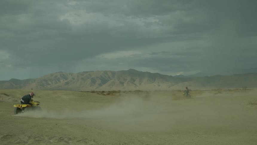 Person rides a four wheeler in the desert