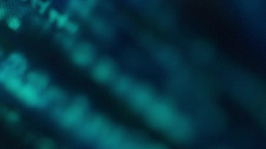 A computer screen of 1's and 0's is filmed close up