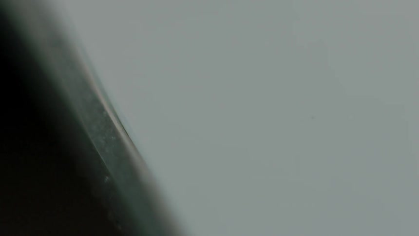 A thin steel bevel is around a white object