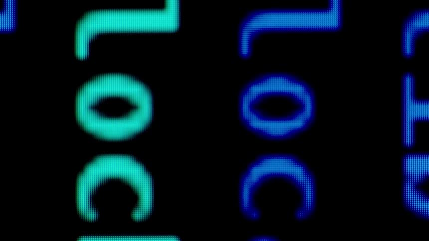 Text on a computer screen is glowing shades of blue and green