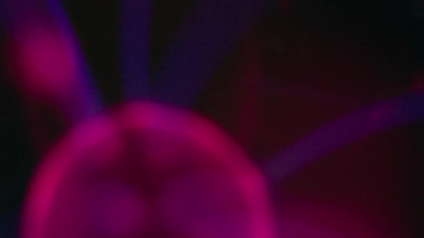 Blue lines of electricity spray off of a purple ball