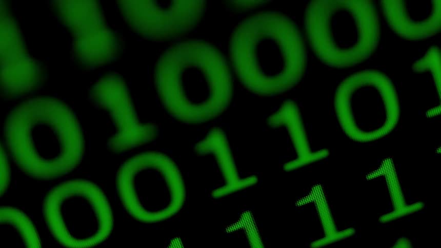 Binary code is displayed on a screen