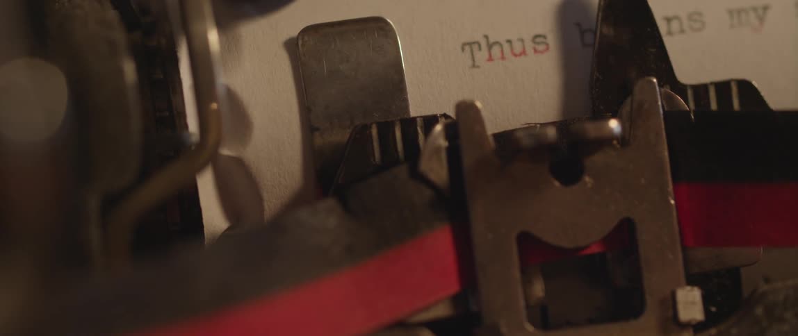 A manual typewriter is typing a sentence