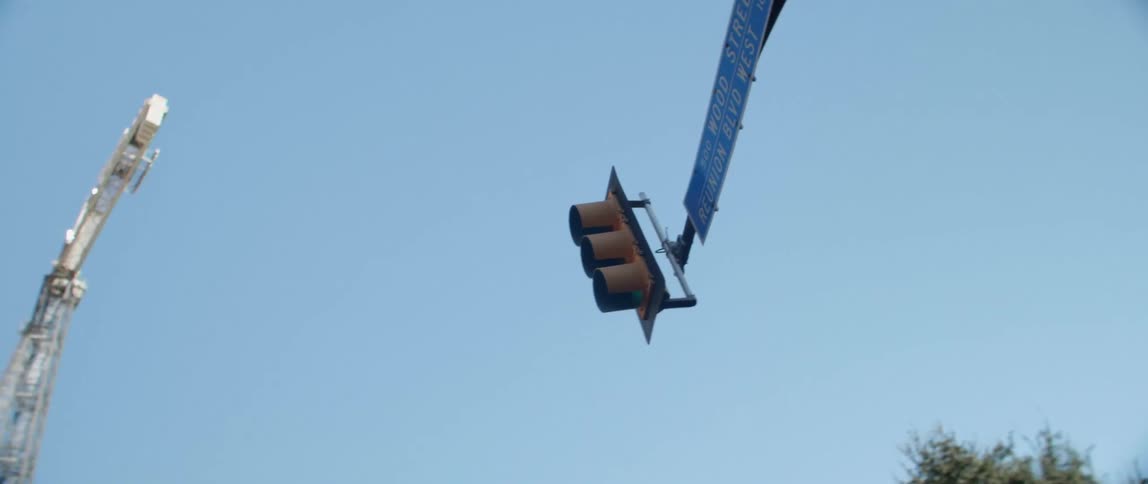A street light hangs above the city street