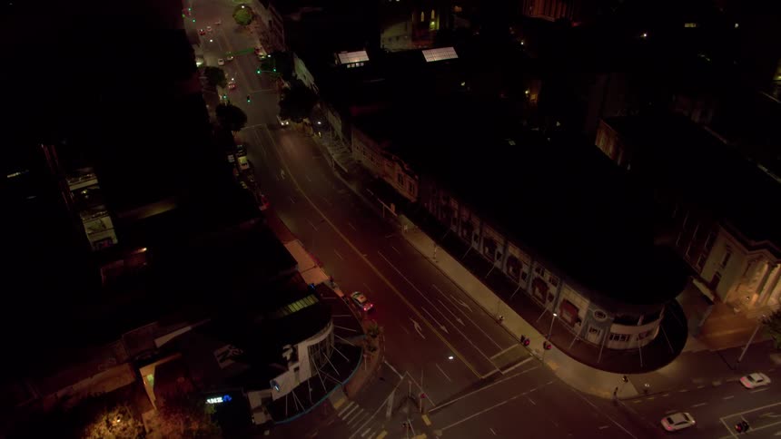 Vehicles travel on a city road at night
