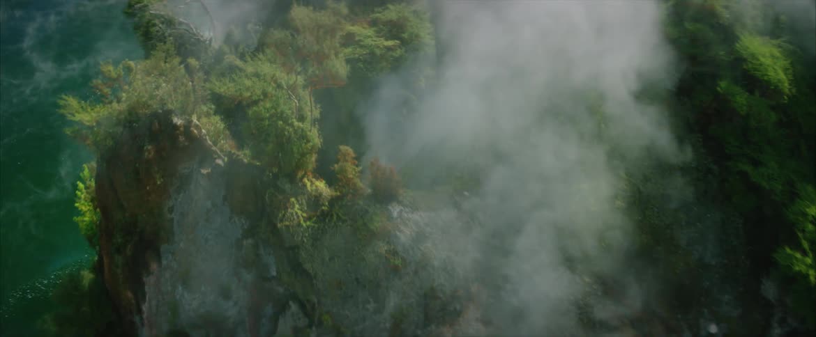 Steam rises from a point on a rocky cliff with deep green water below
