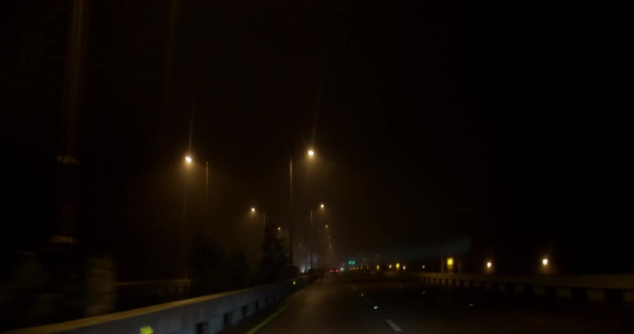 Vehicles travel on a bridge at night