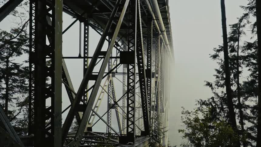 Mist surrounds a tall bridge