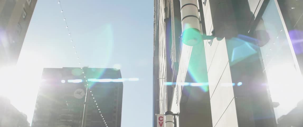 The sun shines on city buildings