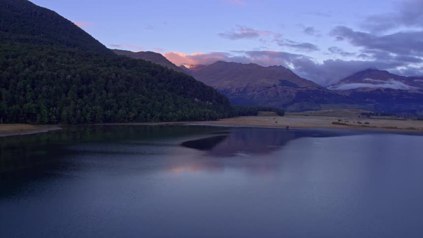 The water in the lake is very calm at sunrise