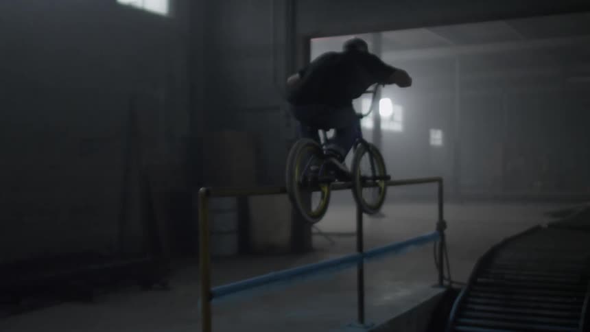 A bmx bike rider grinds on a railing