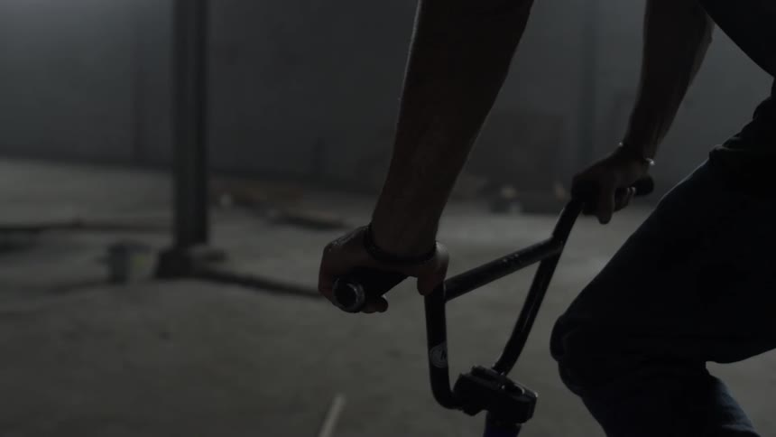 A person is riding their bike in a warehouse