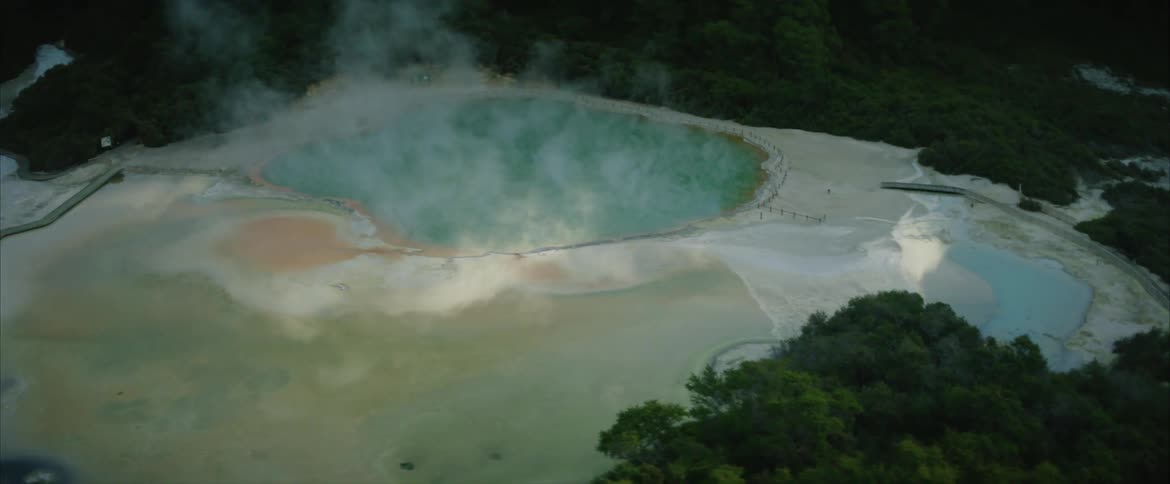 Steam pours from a hot spring