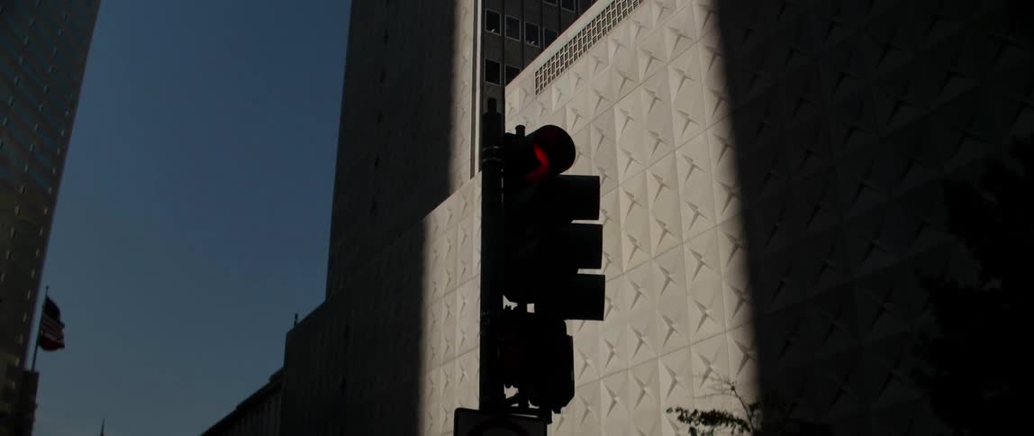A street light is bright red on a street corner
