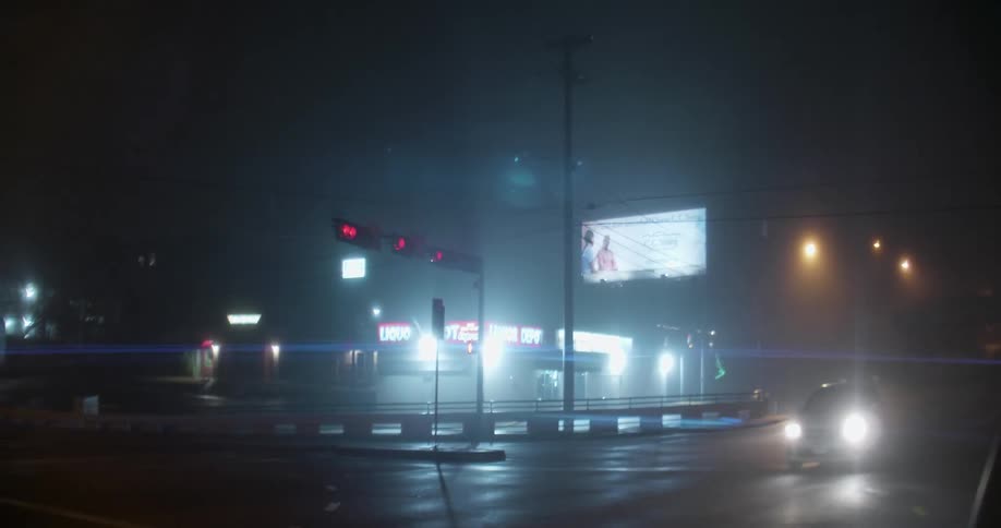 The store on the corner is brightly lit at night