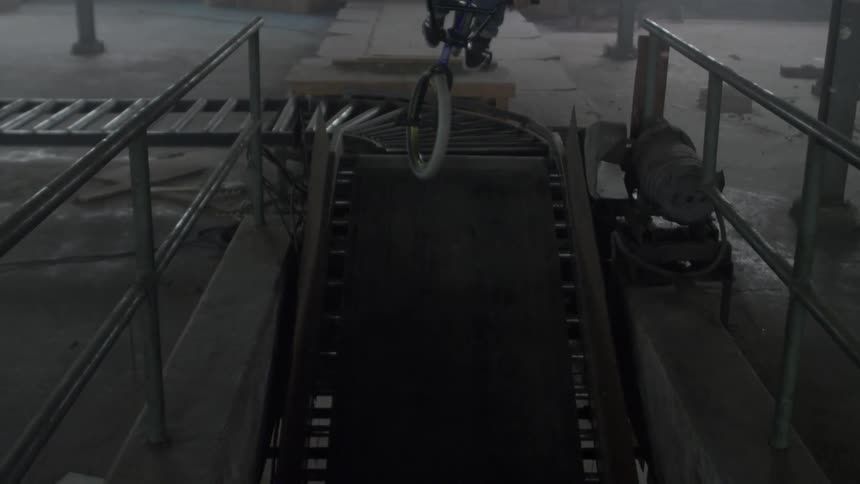 Man jumps with bicycle in a warehouse