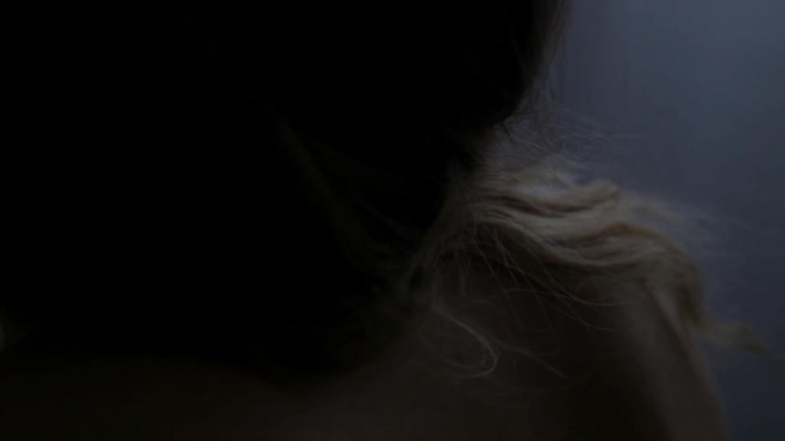 Woman's bare back as she leans over
