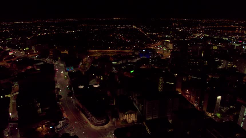 Lights shine and traffic moves in a city at night