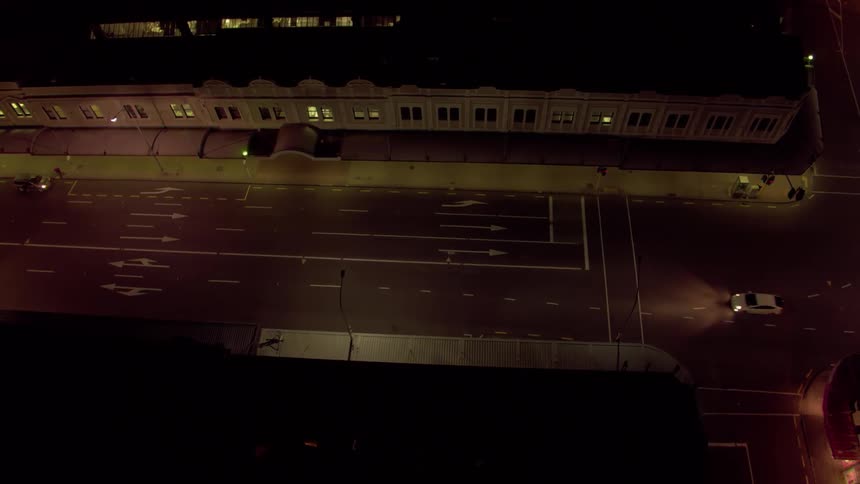 A neighborhood is filmed from a drone at night