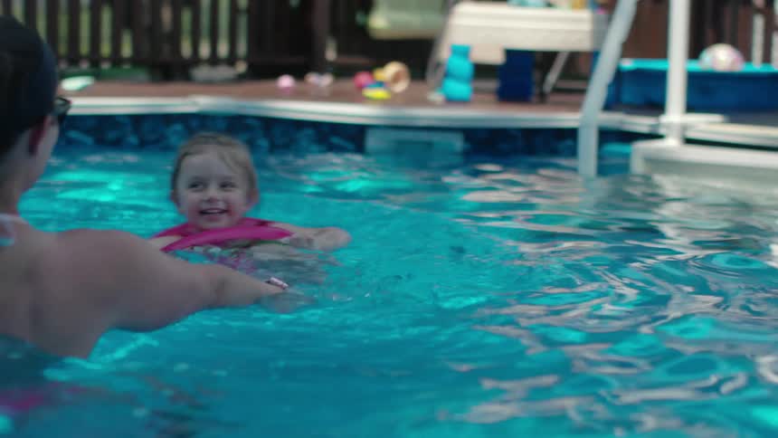 A family swim in a pool