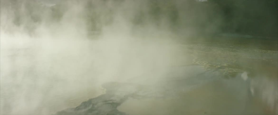 Steam rises over hot springs in the mountains