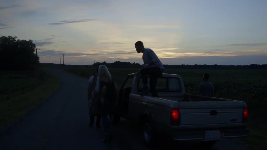 A pickup truck stops and people get out