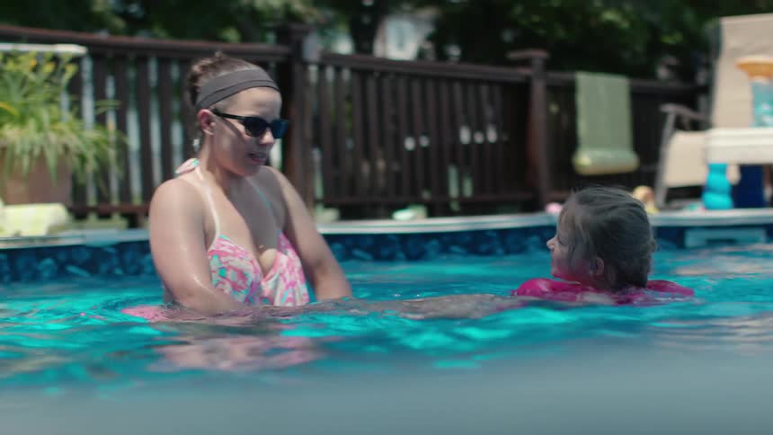 A family swims in a pool