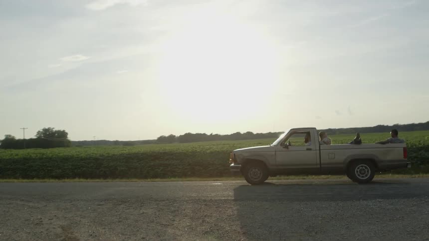 A pickup truck pulls out onto a rural road