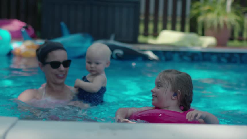 A family is playing around in the pool