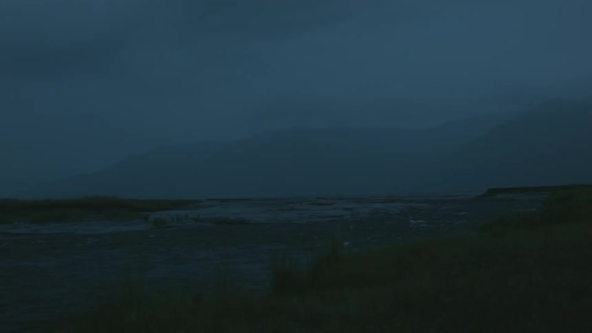 Water flows in a river on a hazy morning