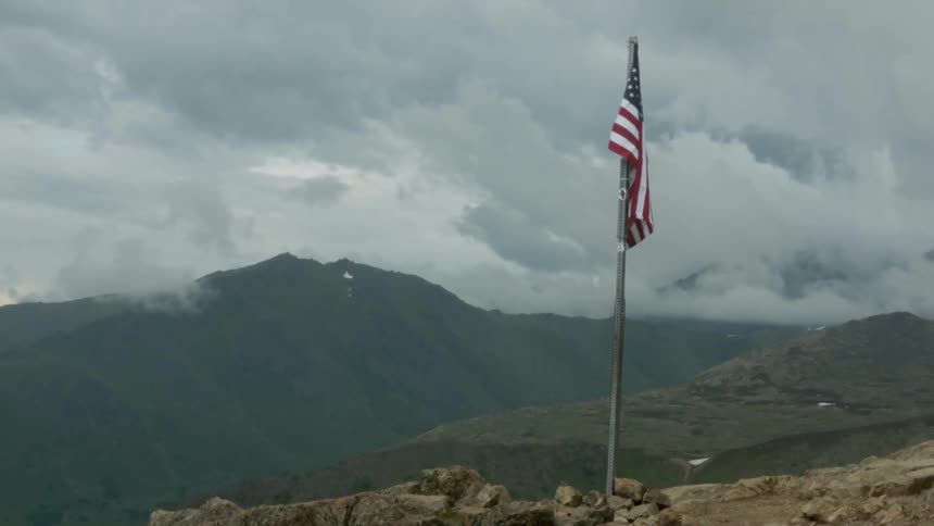 An american flag on a mountain