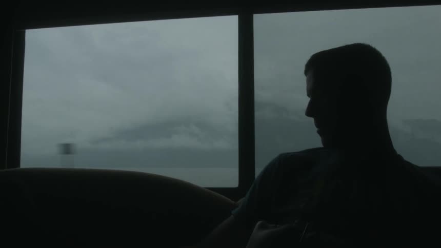 A woman lays on a mans lap in the back of an rv