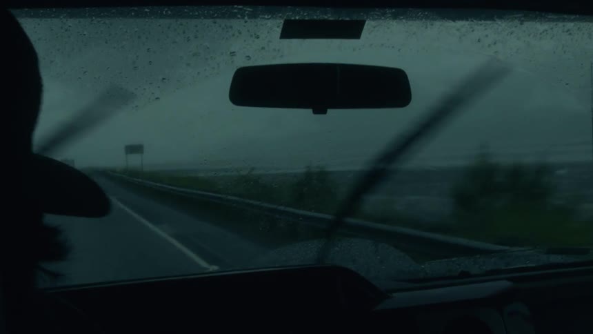 Man drives car during rainstorm