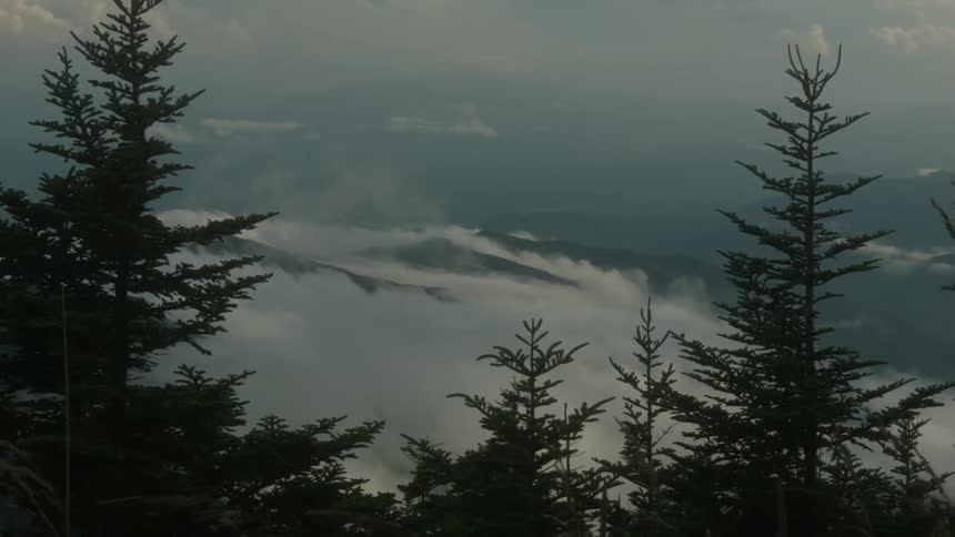 Clouds and fog cover mountain peaks