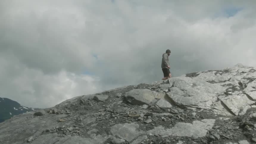Man hikes up a rocky mountainside