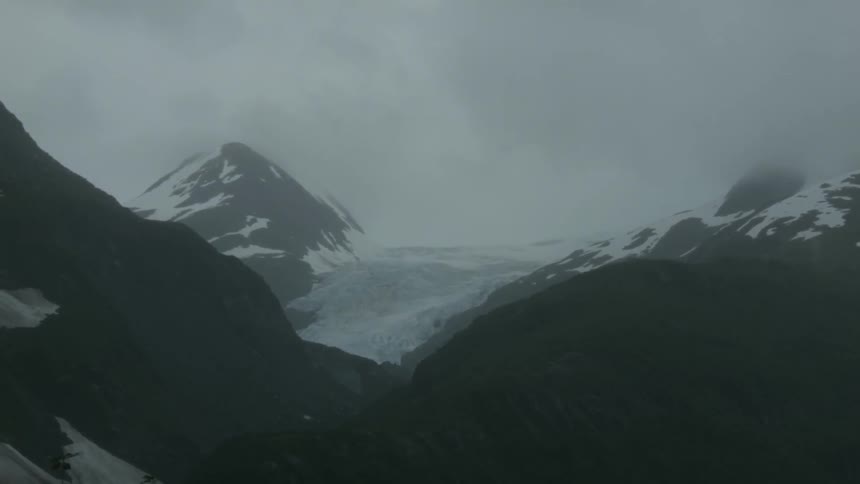 Clouds hang above mountains