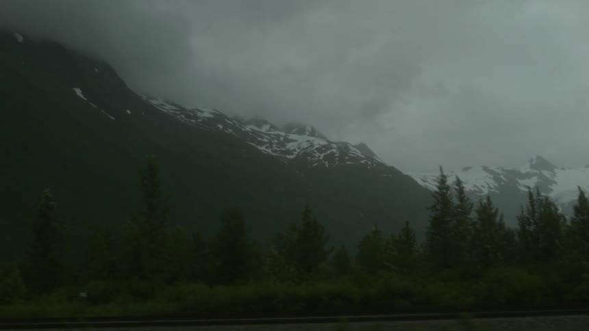 Foggy mountains are in the background