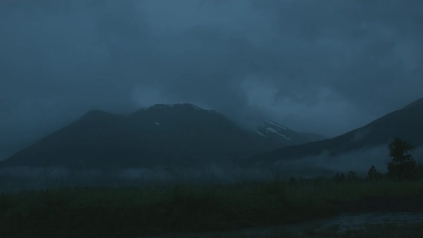 A mountain is shown in the distance at night