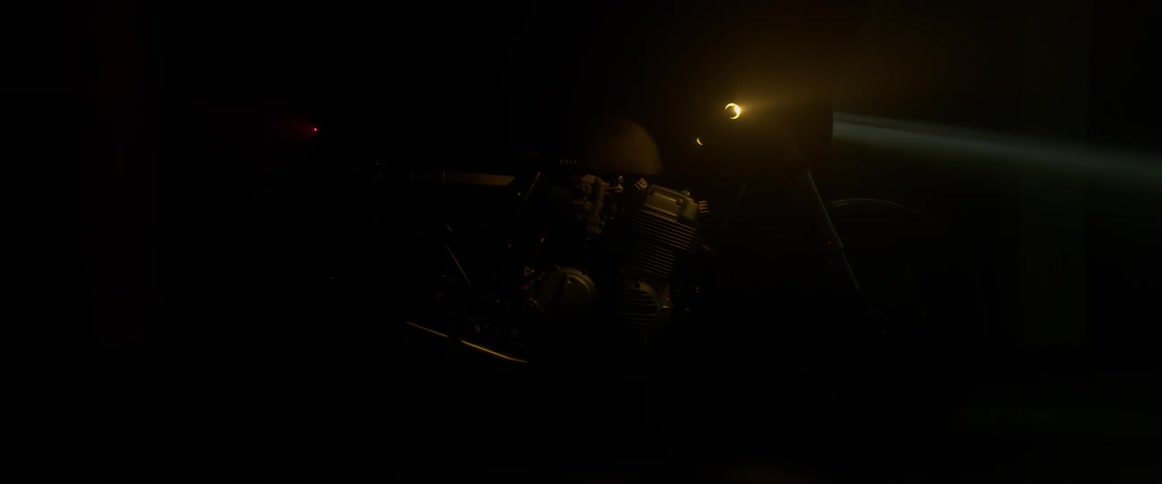 The lights go off on a black motorcycle in a stand