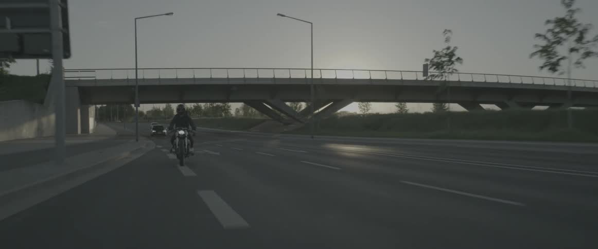 Motorcyclist riding on a highway in an urban area