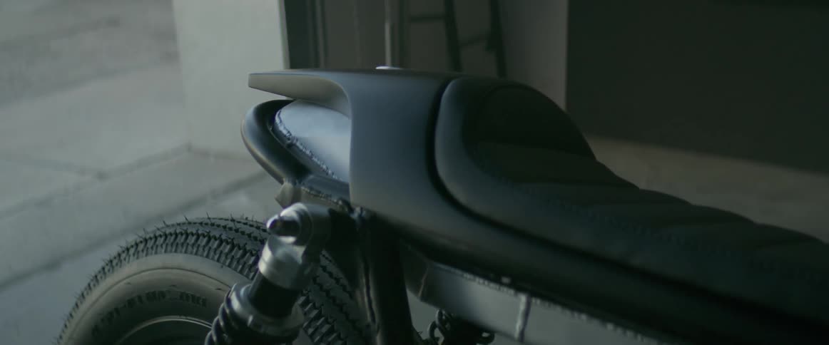 A motorcycle is sitting in a garage during the day