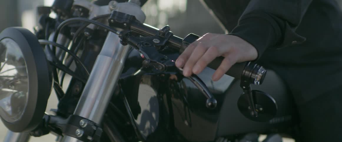 A man is starting his motorcycle