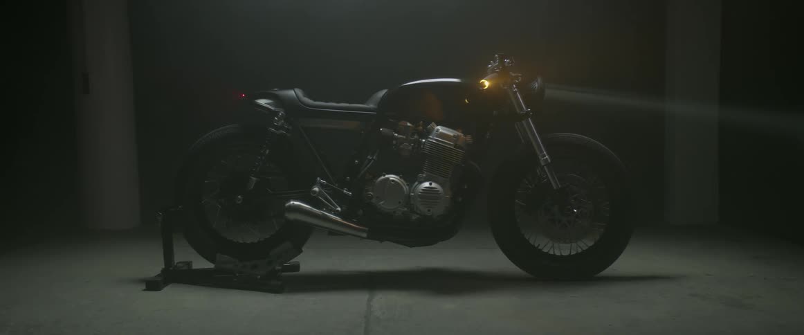 Motorcycle parked indoors at night
