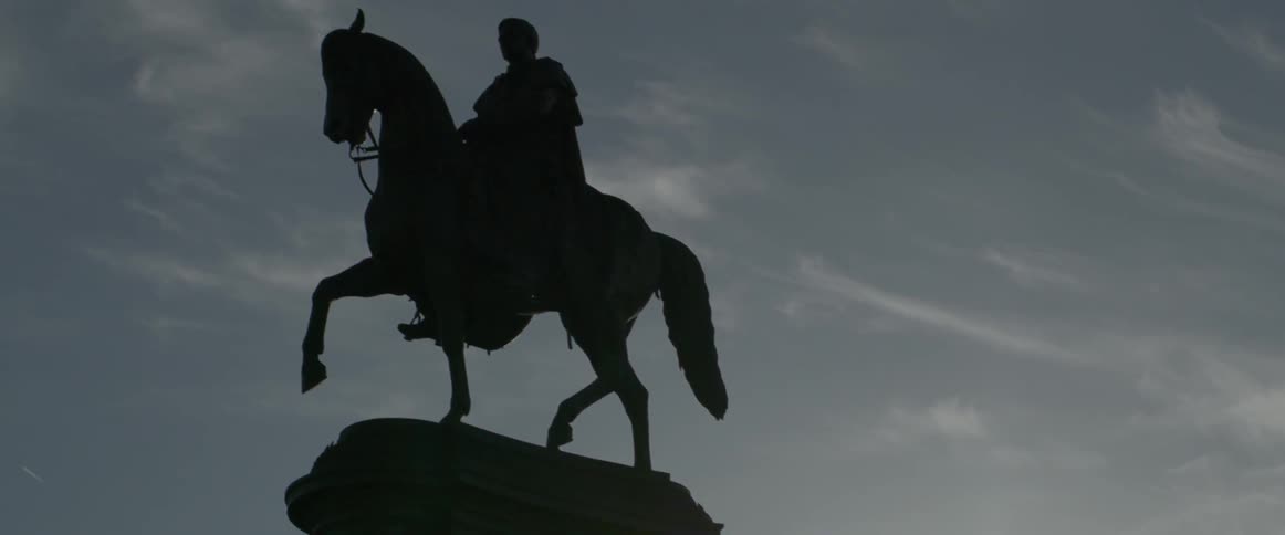 A large horse statue sits on a monument