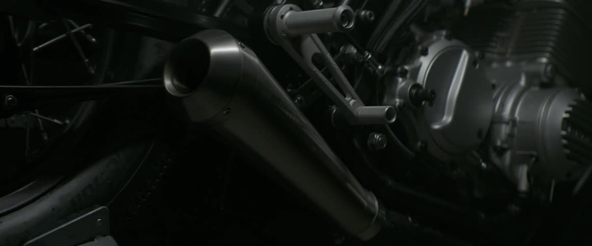 Light illuminates the body of a motorcycle as time lapses