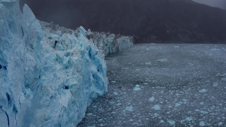 Icebergs tower on the side of water