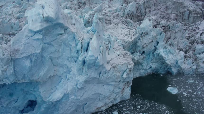 A large iceberg is floating in the water